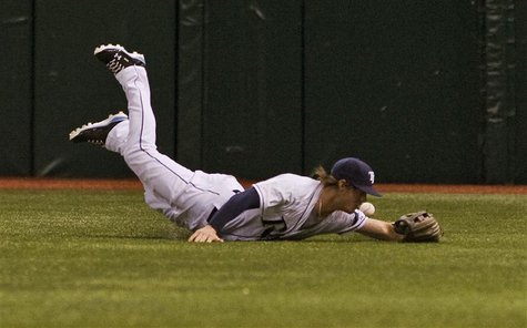 Tampa Bay Rays right fielder Wil Myers comes up short as he dives for Texas Rangers' Elvis Andrus' single during the first inning of their M Tampa Bay Rays right fielder Wil Myers comes up short as he dives for Texas Rangers' Elvis Andrus' single during the first inning of their M