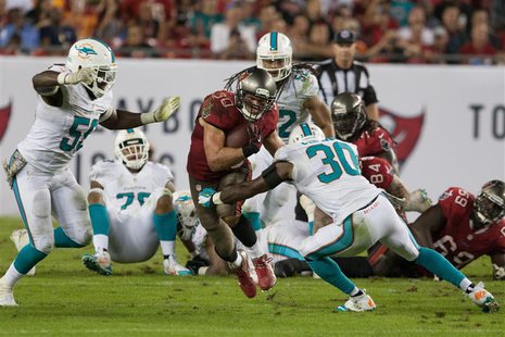 Nov 11, 2013; Tampa, FL, USA; Miami Dolphins strong safety Chris Clemons (30) defends Tampa Bay Buccaneers running back Brian Leonard (30) d Nov 11, 2013; Tampa, FL, USA; Miami Dolphins strong safety Chris Clemons (30) defends Tampa Bay Buccaneers running back Brian Leonard (30) d