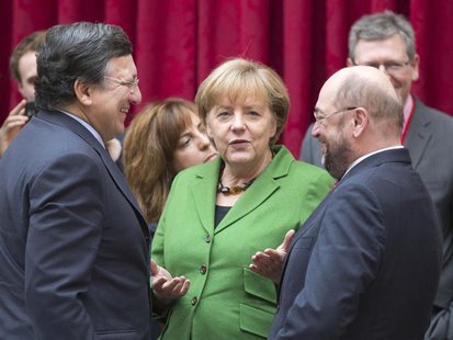 European Commission President Jose Manuel Barroso (L) speaks with German Chancellor Angela Merkel (C) and European Parliament President Mart European Commission President Jose Manuel Barroso (L) speaks with German Chancellor Angela Merkel (C) and European Parliament President Mart