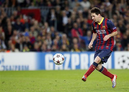Barcelona's Lionel Messi kicks the ball to score his second goal against AC Milan during their Champions League soccer match at Nou Camp sta Barcelona's Lionel Messi kicks the ball to score his second goal against AC Milan during their Champions League soccer match at Nou Camp sta