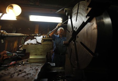 A man produces machine parts inside a factory in Tokyo August 12, 2013. REUTERS/Yuya Shino A man produces machine parts inside a factory in Tokyo August 12, 2013. REUTERS/Yuya Shino