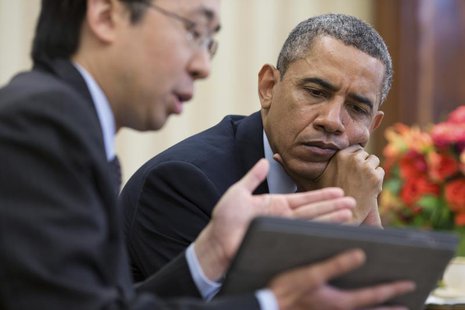 U.S. President Barack Obama watches as Todd Park (L), Assistant to the President and Chief Technology Officer, shows him information on a ta U.S. President Barack Obama watches as Todd Park (L), Assistant to the President and Chief Technology Officer, shows him information on a ta