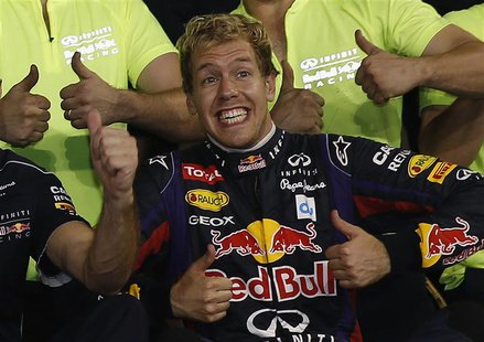 Red Bull Formula One driver Sebastian Vettel of Germany gestures as he celebrates with the Red Bull team after winning the Abu Dhabi F1 Gran Red Bull Formula One driver Sebastian Vettel of Germany gestures as he celebrates with the Red Bull team after winning the Abu Dhabi F1 Gran