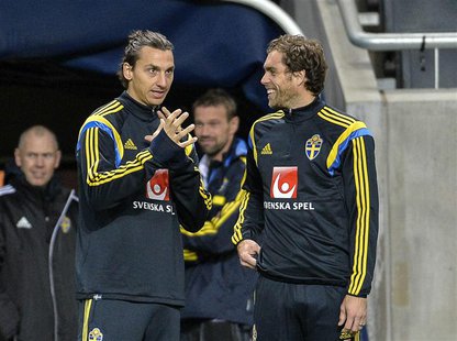 Sweden's Zlatan Ibrahimovic (L) talks to teammate Johan Elmander during a soccer training session at Friends Arena in Stockholm November 13, Sweden's Zlatan Ibrahimovic (L) talks to teammate Johan Elmander during a soccer training session at Friends Arena in Stockholm November 13,