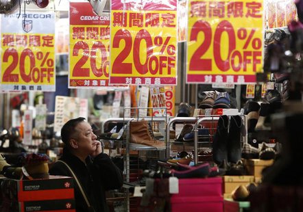 A man looks at items in a shoe store at a shopping district in Tokyo in this October 24, 2013 file photo. REUTERS/Yuya Shino/Files A man looks at items in a shoe store at a shopping district in Tokyo in this October 24, 2013 file photo. REUTERS/Yuya Shino/Files