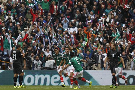 Mexico's Paul Aguilar (C) celebrates his goal with Raul Jimenez (L) and Juan Medina during their 2014 World Cup qualifying playoff first leg Mexico's Paul Aguilar (C) celebrates his goal with Raul Jimenez (L) and Juan Medina during their 2014 World Cup qualifying playoff first leg