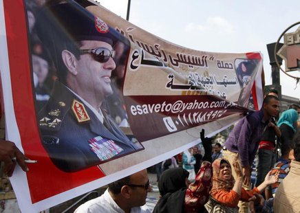 Supporters of the military hold a banner of Army chief General Abdel Fattah al-Sisi outside the Egyptian High Court in Cairo November 4, 201 Supporters of the military hold a banner of Army chief General Abdel Fattah al-Sisi outside the Egyptian High Court in Cairo November 4, 201