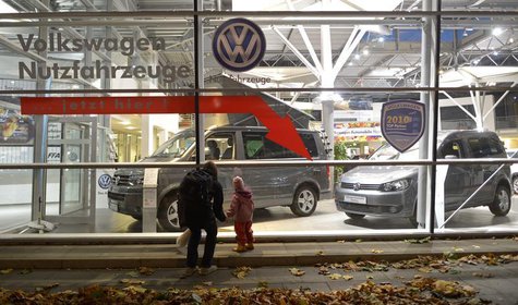 A woman and a child look at cars of German carmaker Volkswagen in a shop of a VW dealership in Hamburg, October 28, 2013. Volkswagen is due A woman and a child look at cars of German carmaker Volkswagen in a shop of a VW dealership in Hamburg, October 28, 2013. Volkswagen is due