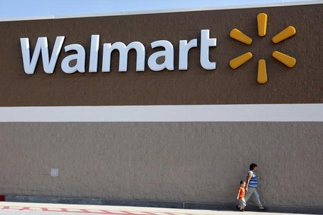 People walk past a Wal-Mart sign in Rogers, Arkansas June 4, 2009. REUTERS/Jessica Rinaldi People walk past a Wal-Mart sign in Rogers, Arkansas June 4, 2009. REUTERS/Jessica Rinaldi