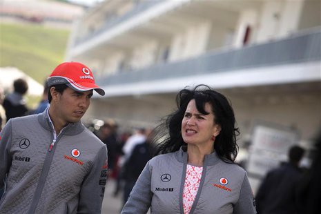 McLaren Formula One driver Sergio Perez (L) of Mexico arrives to the track at the Circuit of The Americas in Austin, Texas November 14, 2013 McLaren Formula One driver Sergio Perez (L) of Mexico arrives to the track at the Circuit of The Americas in Austin, Texas November 14, 2013