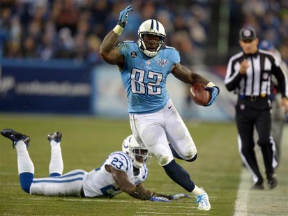Nov 14, 2013; Nashville, TN, USA; Tennessee Titans tight end Delanie Walker (82) is pursued by Indianapolis Colts cornerback Vontae Davis (2 Nov 14, 2013; Nashville, TN, USA; Tennessee Titans tight end Delanie Walker (82) is pursued by Indianapolis Colts cornerback Vontae Davis (2