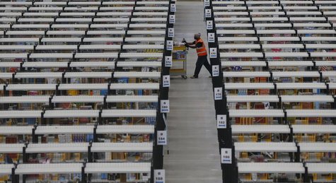 A worker collects orders at Amazon's fulfilment centre in Rugeley, central England December 11, 2012. REUTERS/Phil Noble A worker collects orders at Amazon's fulfilment centre in Rugeley, central England December 11, 2012. REUTERS/Phil Noble