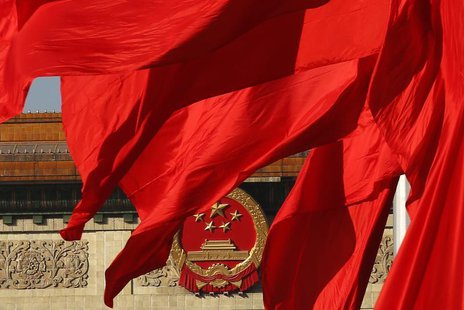 The Great Hall of the People, where the Chinese Communist Party plenum is being held, is seen behinds red flags in Tiananmen square in Beiji The Great Hall of the People, where the Chinese Communist Party plenum is being held, is seen behinds red flags in Tiananmen square in Beiji
