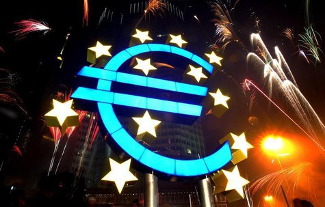 Fireworks illuminate the sky around a huge euro sculpture, designed by German artist Ottmar Hoerl, in front of the headquarters of the Europ Fireworks illuminate the sky around a huge euro sculpture, designed by German artist Ottmar Hoerl, in front of the headquarters of the Europ