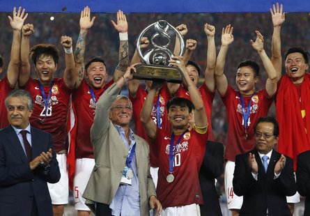 China's Guangzhou Evergrande coach Marcello Lippi (front 2nd L) and player Zheng Zhi (10) hold up the trophy after winning their final match China's Guangzhou Evergrande coach Marcello Lippi (front 2nd L) and player Zheng Zhi (10) hold up the trophy after winning their final match