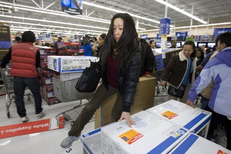 A woman jumps over computers at a Walmart store in Oakland, California, November 28, 2008. REUTERS/Kimberly White A woman jumps over computers at a Walmart store in Oakland, California, November 28, 2008. REUTERS/Kimberly White