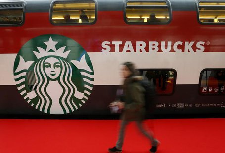 A woman walks past a Starbucks logo painted on a railway coach at the main train station in Zurich November 14, 2013. REUTERS/Arnd Wiegmann A woman walks past a Starbucks logo painted on a railway coach at the main train station in Zurich November 14, 2013. REUTERS/Arnd Wiegmann