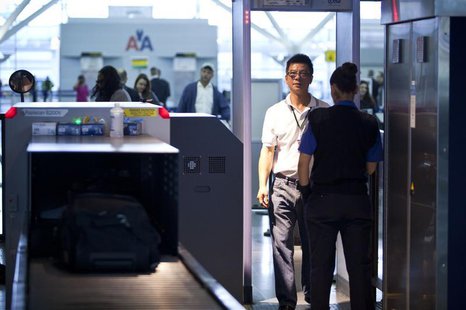 A traveler walks through a metal detector at a security check point in John F. Kennedy Airport in New York, February, 29, 2012. REUTERS/Andr A traveler walks through a metal detector at a security check point in John F. Kennedy Airport in New York, February, 29, 2012. REUTERS/Andr