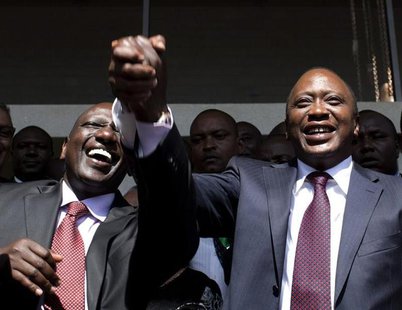 President-elect Uhuru Kenyatta (R) greets his supporters with his running mate, former cabinet minister William Ruto after attending a news President-elect Uhuru Kenyatta (R) greets his supporters with his running mate, former cabinet minister William Ruto after attending a news
