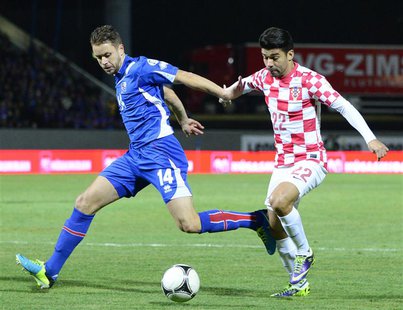 Eduardo of Croatia (R) challenges Kari Arnason of Iceland during their 2014 World Cup playoff soccer match in Reyjkavik November 15, 2013. R Eduardo of Croatia (R) challenges Kari Arnason of Iceland during their 2014 World Cup playoff soccer match in Reyjkavik November 15, 2013. R