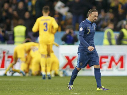 France's Franck Ribery (front) walks after Ukraine's Andriy Yarmolenko celebrates his goal with team mates (back) during the 2014 World Cup France's Franck Ribery (front) walks after Ukraine's Andriy Yarmolenko celebrates his goal with team mates (back) during the 2014 World Cup