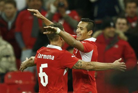 Chile's Alexis Sanchez (R) celebrates a second goal against England's with team mate Carlos Carmona (L) during their international friendly Chile's Alexis Sanchez (R) celebrates a second goal against England's with team mate Carlos Carmona (L) during their international friendly