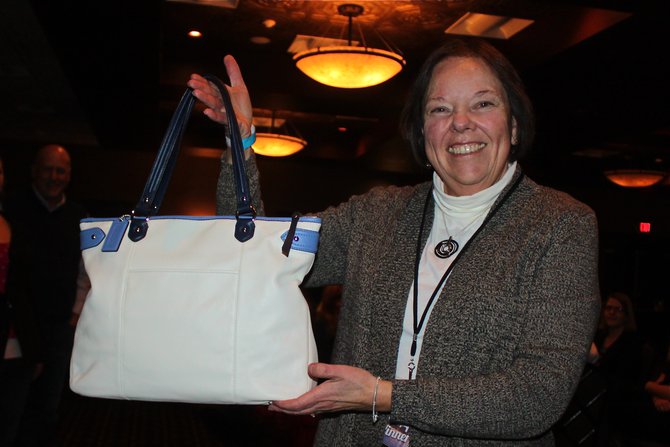 Happy with a purse she won on WIXX!