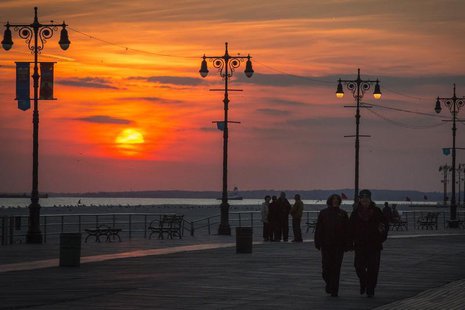 People walk at the Coney Island boardwalk during sunset on the one-year anniversary of Hurricane Sandy in the Brooklyn borough of New York, People walk at the Coney Island boardwalk during sunset on the one-year anniversary of Hurricane Sandy in the Brooklyn borough of New York,