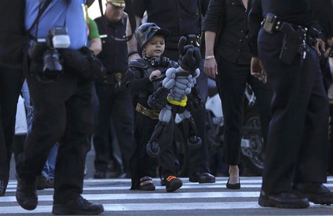 Five-year-old leukemia survivor Miles Scott, dressed as "Batkid" looks at a Batman balloon after a ceremony arranged by the Make- A - Wish F Five-year-old leukemia survivor Miles Scott, dressed as "Batkid" looks at a Batman balloon after a ceremony arranged by the Make- A - Wish F