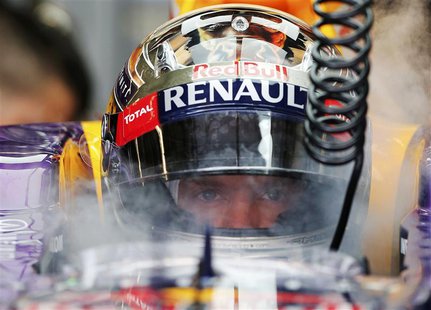 Red Bull Formula One driver Sebastian Vettel of Germany is sprayed with dried ice to keep cool during the third practice session of the Aust Red Bull Formula One driver Sebastian Vettel of Germany is sprayed with dried ice to keep cool during the third practice session of the Aust