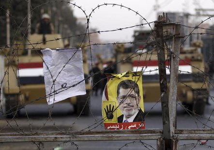 A poster of ousted Egyptian President Mohamed Mursi is pictured on barbed wires during a protest by his supporters at El-Thadiya presidentia A poster of ousted Egyptian President Mohamed Mursi is pictured on barbed wires during a protest by his supporters at El-Thadiya presidentia
