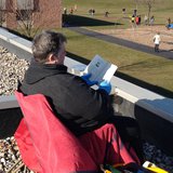 Random Lake Elementary Principal Sandra Mountain enjoys a book on the school's roof. Random Lake Elementary Principal Sandra Mountain enjoys a book on the school's roof.