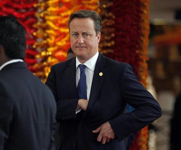 Britain's Prime Minister David Cameron reaches into his pocket as he arrives for the official photograph of Commonwealth heads of states dur Britain's Prime Minister David Cameron reaches into his pocket as he arrives for the official photograph of Commonwealth heads of states dur