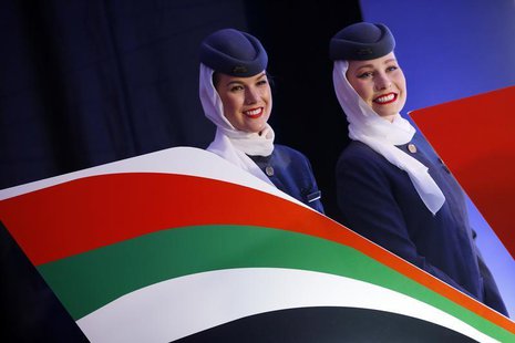 Etihad Airways stewardess smile after signing a strategic partnership deal in Belgrade August 1, 2013. REUTERS/Marko Djurica Etihad Airways stewardess smile after signing a strategic partnership deal in Belgrade August 1, 2013. REUTERS/Marko Djurica