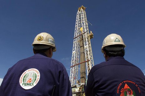 Two engineers with Mexico's state owned oil company, PEMEX (Petroleos de Mexico), watch work on an oil platform in the Sen oil field, in the Two engineers with Mexico's state owned oil company, PEMEX (Petroleos de Mexico), watch work on an oil platform in the Sen oil field, in the