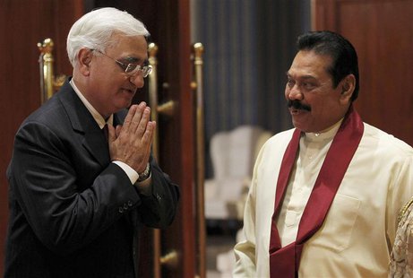 India's Foreign Minister Salman Khurshid (L) gestures next to Sri Lanka's President Mahinda Rajapaksa as he arrives for a banquet dinner for India's Foreign Minister Salman Khurshid (L) gestures next to Sri Lanka's President Mahinda Rajapaksa as he arrives for a banquet dinner for