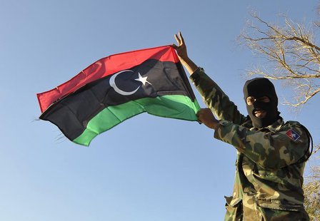 A member of the Libyan army's Thunderbolt Brigade flies the Libyan flag as the army prepares for deployment in Benghazi, November 8, 2013. R A member of the Libyan army's Thunderbolt Brigade flies the Libyan flag as the army prepares for deployment in Benghazi, November 8, 2013. R