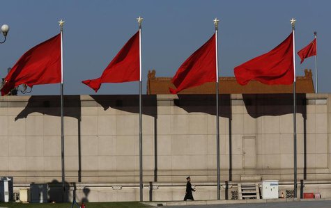 A Paramilitary soldier walks underneath red flags on the Tiananmen square next to the Great Hall of the People where the Chinese Communist P A Paramilitary soldier walks underneath red flags on the Tiananmen square next to the Great Hall of the People where the Chinese Communist P