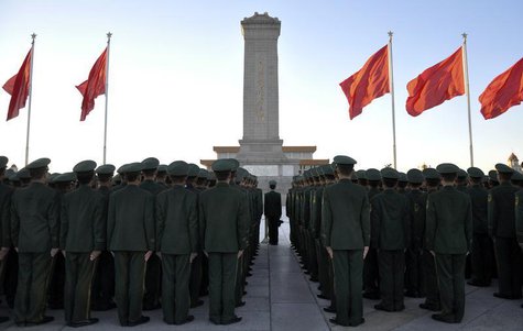 Paramilitary policemen stand in formation as they pay tribute to the Monument to the People's Heroes on Tiananmen Square in Beijing, Novembe Paramilitary policemen stand in formation as they pay tribute to the Monument to the People's Heroes on Tiananmen Square in Beijing, Novembe