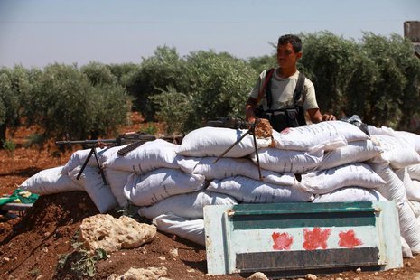 A Free Syrian Army member is seen behind sandbags at a checkpoint during a siege on the Kurdish city of Afrin, which is under the control of A Free Syrian Army member is seen behind sandbags at a checkpoint during a siege on the Kurdish city of Afrin, which is under the control of