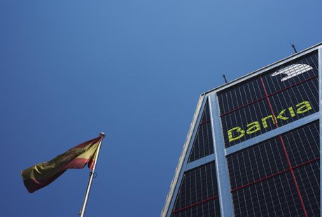 A Spanish flag flies next to the headquarters of Bankia bank in Madrid July 24, 2012. REUTERS/Susana Vera A Spanish flag flies next to the headquarters of Bankia bank in Madrid July 24, 2012. REUTERS/Susana Vera