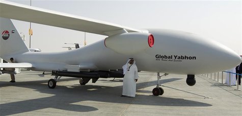 A visitor speaks on his phone in the shade of unmanned drone during the Dubai Airshow November 18, 2013. REUTERS/Caren Firouz A visitor speaks on his phone in the shade of unmanned drone during the Dubai Airshow November 18, 2013. REUTERS/Caren Firouz