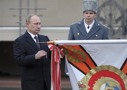 Russia's President Vladimir Putin (L) takes part in a ceremony to award the Margelov Ryazan Higher Airborne Command School with the Order of Russia's President Vladimir Putin (L) takes part in a ceremony to award the Margelov Ryazan Higher Airborne Command School with the Order of