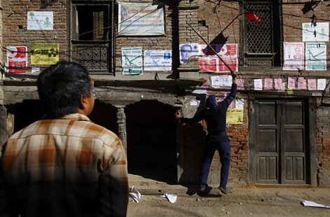 A police personnel recruited for the Constituent Assembly election, removes a party flag near the polling station a day before the election A police personnel recruited for the Constituent Assembly election, removes a party flag near the polling station a day before the election