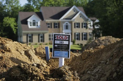 A completed house (rear) is seen behind the earthworks of a home currently under construction at the Mid-Atlantic Builder's 'The Villages of A completed house (rear) is seen behind the earthworks of a home currently under construction at the Mid-Atlantic Builder's 'The Villages of