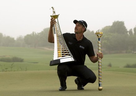 Henrik Stenson of Sweden poses with his trophies after winning the DP World Tour Championship in Dubai November 17, 2013. REUTERS/Caren Firo Henrik Stenson of Sweden poses with his trophies after winning the DP World Tour Championship in Dubai November 17, 2013. REUTERS/Caren Firo