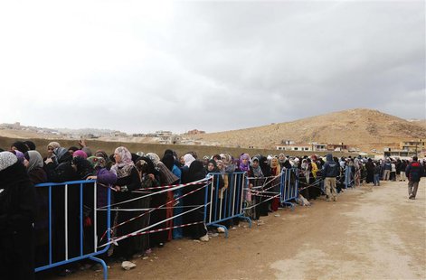 Syrians, fleeing the violence from the Syrian town of Qara, queue to register to get help from relief agencies at the Lebanese border town o Syrians, fleeing the violence from the Syrian town of Qara, queue to register to get help from relief agencies at the Lebanese border town o