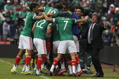 Mexico's coach Miguel Herrera (R) celebrates a goal with his players during their 2014 World Cup qualifying playoff first leg soccer match a Mexico's coach Miguel Herrera (R) celebrates a goal with his players during their 2014 World Cup qualifying playoff first leg soccer match a