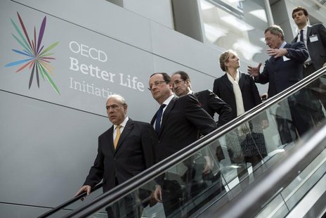 France's President Francois Hollande (2ndL) and Economic Co-operation and Development (OECD) General Secretary Angel Gurria (L) arrive to at France's President Francois Hollande (2ndL) and Economic Co-operation and Development (OECD) General Secretary Angel Gurria (L) arrive to at