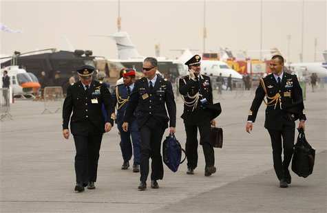 Military visitors walk during the sandstorm at the Dubai Airshow November 17, 2013. The flying display was cancelled due to the sandstorm. R Military visitors walk during the sandstorm at the Dubai Airshow November 17, 2013. The flying display was cancelled due to the sandstorm. R